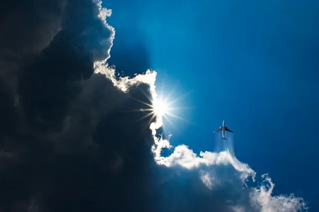 Twin-engined aircraft avoid turbulent cloud in flight.